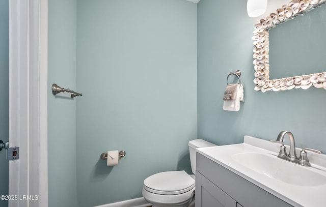half bath featuring toilet and vanity