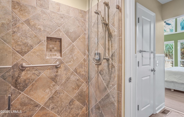 bathroom with visible vents, tiled shower, and ensuite bathroom