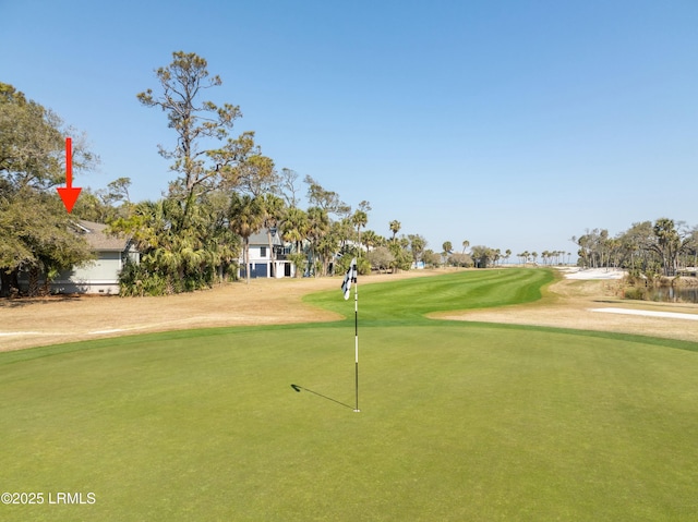 view of home's community featuring a yard and golf course view