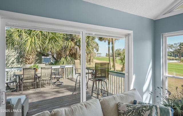 sunroom featuring vaulted ceiling