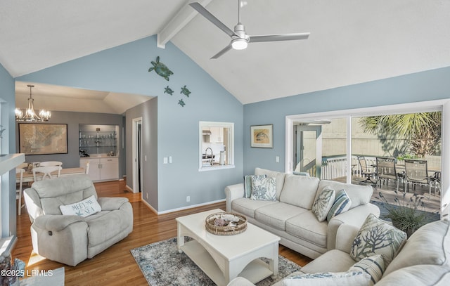 living room with high vaulted ceiling, ceiling fan with notable chandelier, wood finished floors, baseboards, and beamed ceiling
