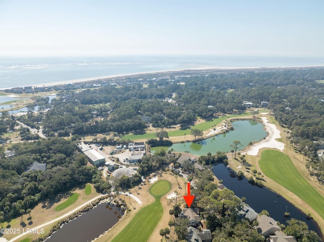 birds eye view of property featuring golf course view and a water view