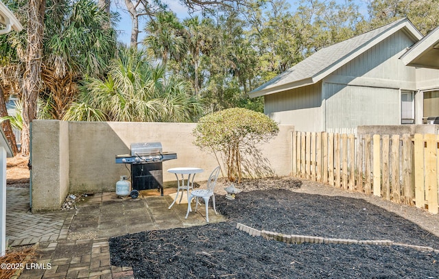 view of yard featuring fence and a patio