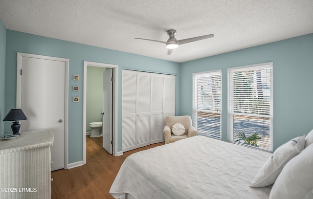 bedroom featuring a textured ceiling, a closet, connected bathroom, and wood finished floors