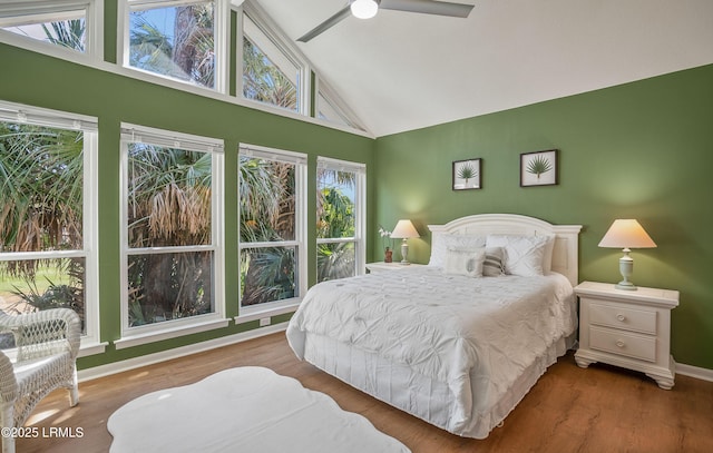 bedroom featuring high vaulted ceiling, ceiling fan, baseboards, and wood finished floors