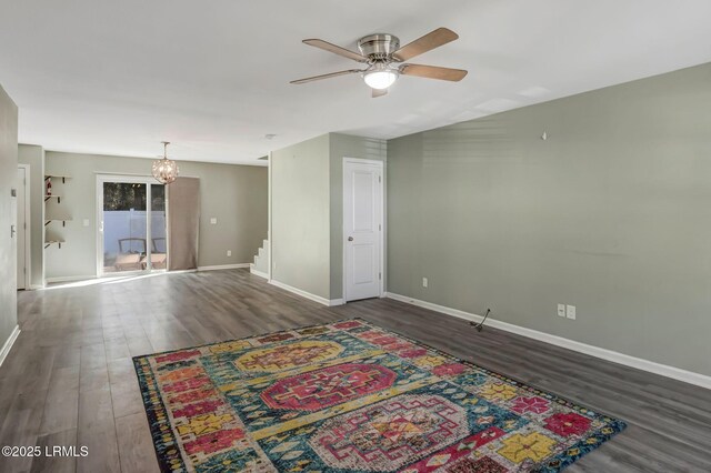 238 Turkey Oak Dr, Bluffton, SC 29910 - spare room featuring baseboards, wood finished floors, stairs, and ceiling fan with notable chandelier