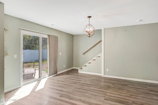 238 Turkey Oak Dr, Bluffton, SC 29910 - unfurnished room featuring a healthy amount of sunlight, baseboards, an inviting chandelier, and wood finished floors