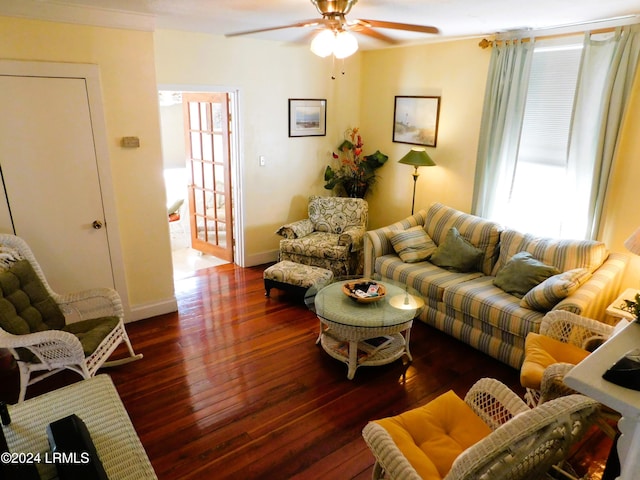 living room with ornamental molding, dark hardwood / wood-style floors, and ceiling fan