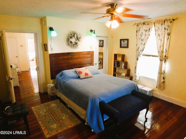 bedroom with dark hardwood / wood-style floors and ceiling fan