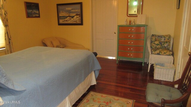 bedroom with dark wood-type flooring