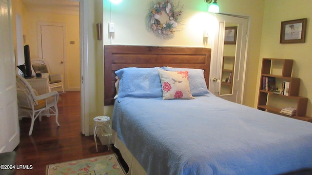 bedroom with dark hardwood / wood-style flooring