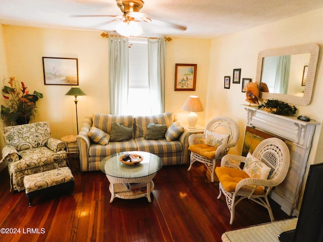 living room featuring ceiling fan, dark hardwood / wood-style floors, and a brick fireplace