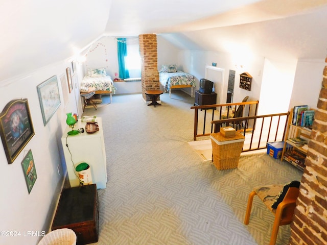 bedroom featuring lofted ceiling and carpet