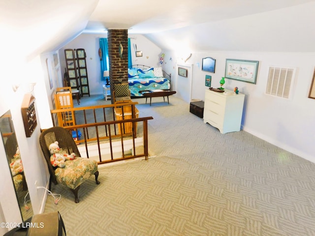 sitting room with decorative columns, vaulted ceiling, and carpet floors