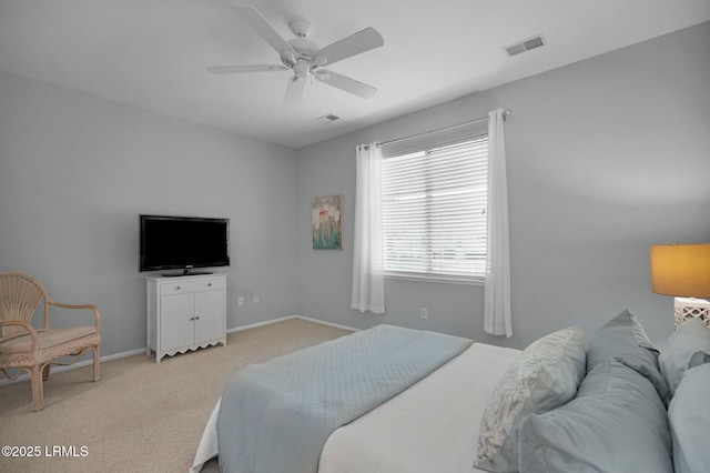 bedroom with baseboards, a ceiling fan, visible vents, and light colored carpet