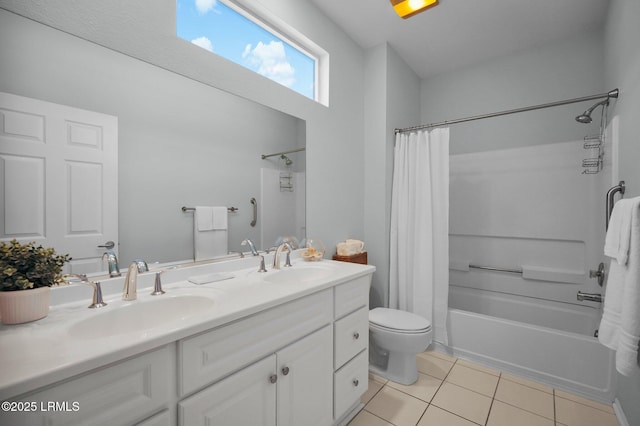 bathroom with double vanity, shower / tub combo with curtain, tile patterned flooring, and a sink