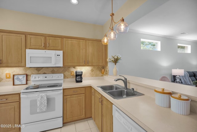 kitchen with tasteful backsplash, a sink, white appliances, and light countertops
