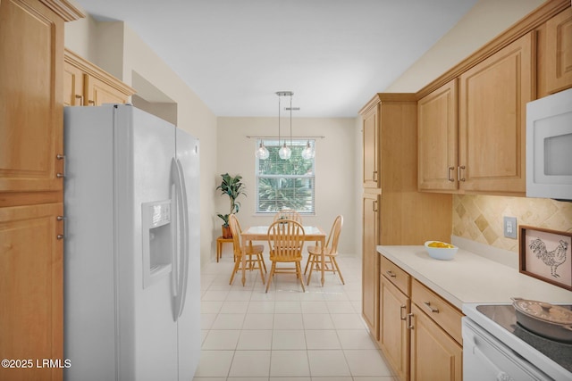 kitchen featuring tasteful backsplash, white appliances, light tile patterned floors, pendant lighting, and light countertops