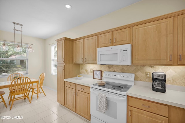 kitchen featuring light countertops, white appliances, and backsplash
