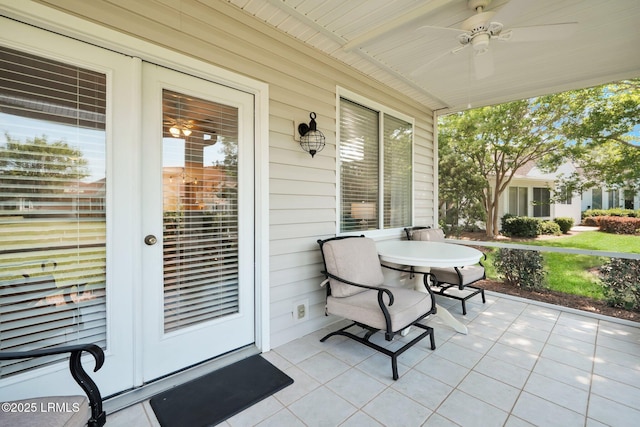 view of patio with outdoor dining area and ceiling fan