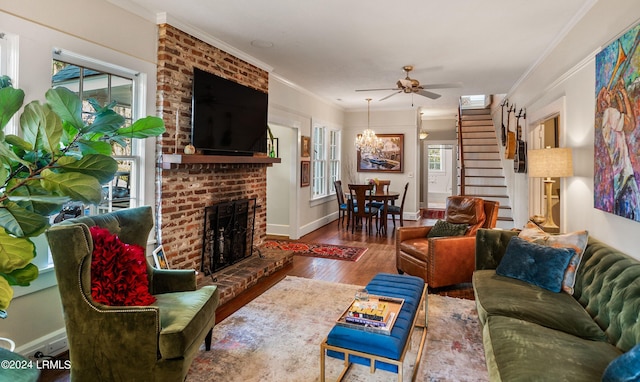 living room with crown molding, a brick fireplace, hardwood / wood-style floors, and ceiling fan