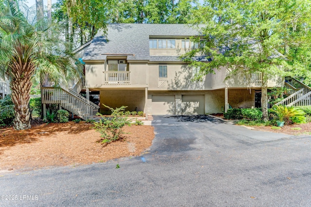 11 Compass Pt Unit 11B, Hilton Head Island, SC 29928 - view of front of property featuring roof with shingles, an attached garage, stairway, and aphalt driveway