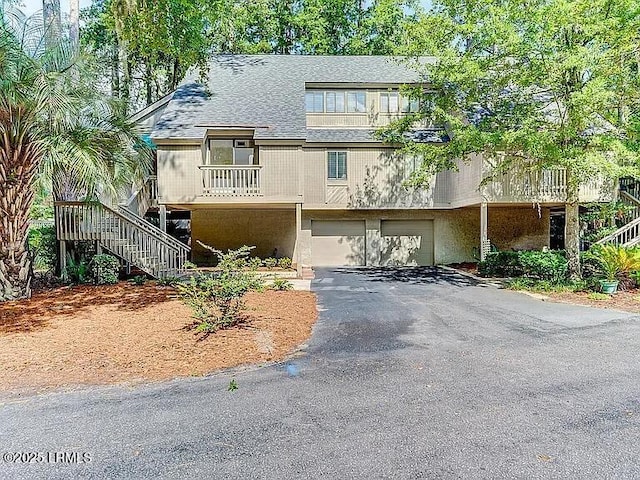 11 Compass Pt Unit 11B, Hilton Head Island, SC 29928 - view of front of home featuring an attached garage, driveway, stairs, and roof with shingles