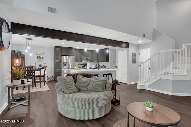 50 Lake Linden Ln Unit 50, Bluffton, SC 29910 - living room with baseboards, stairway, dark wood-type flooring, and a high ceiling