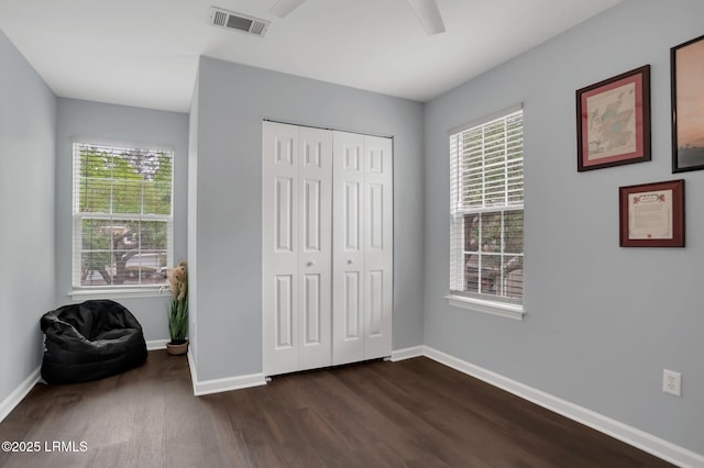 50 Lake Linden Ln Unit 50, Bluffton, SC 29910 - bedroom featuring dark wood-type flooring, multiple windows, baseboards, and a closet