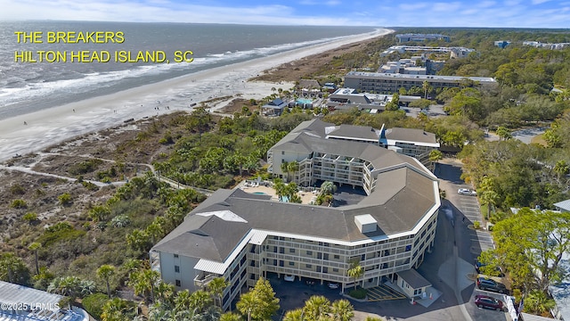 bird's eye view featuring a water view and a beach view