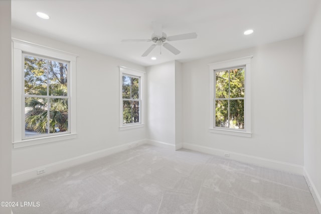 unfurnished room featuring light carpet and ceiling fan