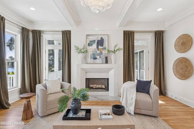 living area with crown molding, beam ceiling, and hardwood / wood-style floors