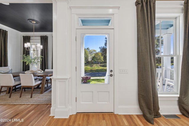 entrance foyer featuring a notable chandelier and light hardwood / wood-style floors