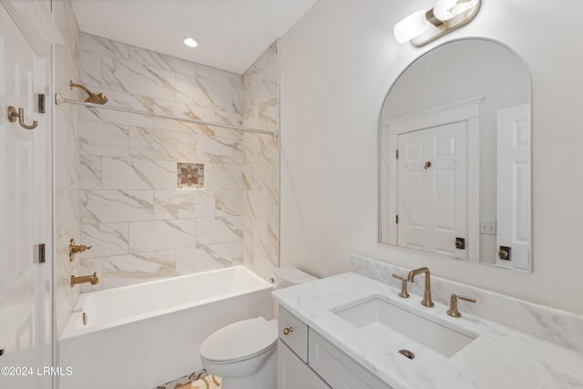 full bathroom with vanity, tiled shower / bath combo, and toilet