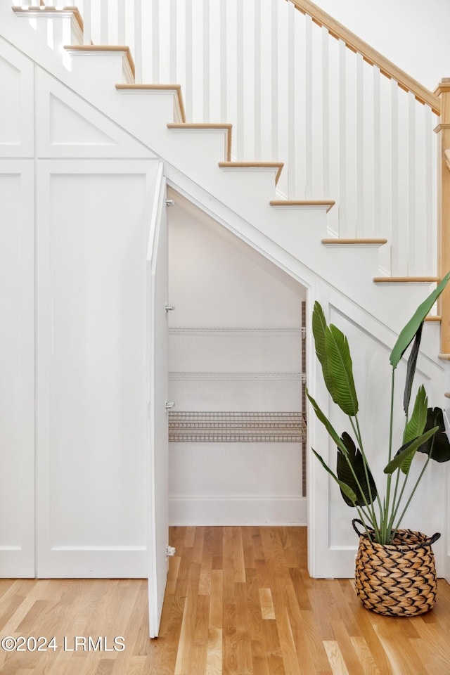 stairway with hardwood / wood-style flooring