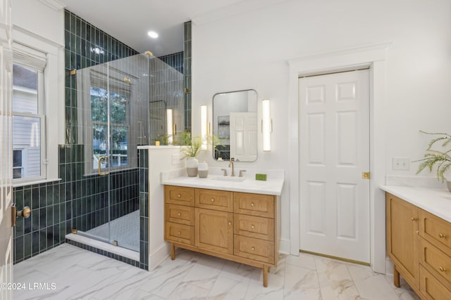 bathroom with a shower with door and vanity