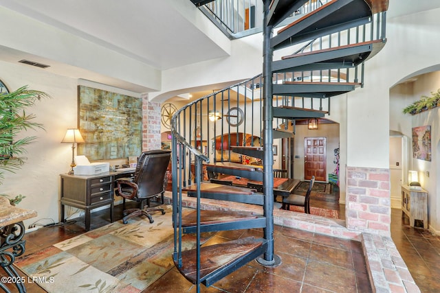 618 Dolphin Anx, Fripp Island, SC 29920 - staircase featuring arched walkways and a high ceiling