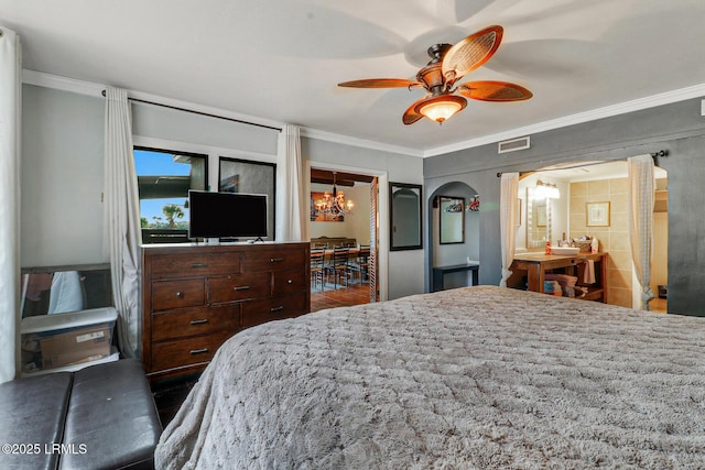 618 Dolphin Anx, Fripp Island, SC 29920 - bedroom featuring ornamental molding, a chandelier, arched walkways, and a ceiling fan