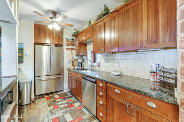 618 Dolphin Anx, Fripp Island, SC 29920 - kitchen featuring appliances with stainless steel finishes, a sink, a ceiling fan, backsplash, and brown cabinets