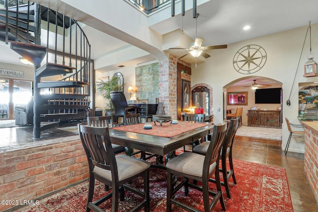 618 Dolphin Anx, Fripp Island, SC 29920 - dining space with a ceiling fan, a high ceiling, arched walkways, recessed lighting, and brick wall