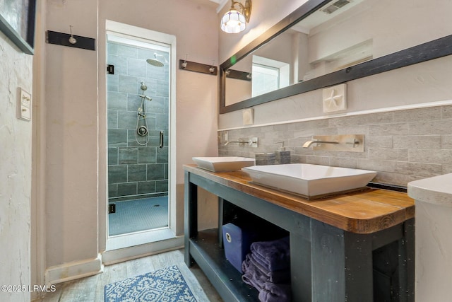 618 Dolphin Anx, Fripp Island, SC 29920 - bathroom featuring wood finished floors, a shower stall, and double vanity