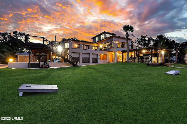 618 Dolphin Anx, Fripp Island, SC 29920 - back of house at dusk featuring a lawn and a balcony