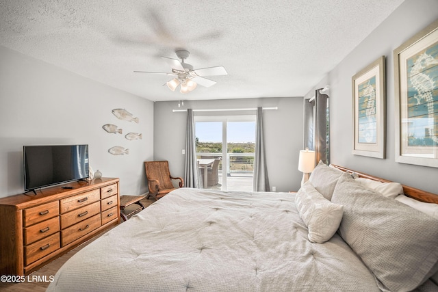 bedroom featuring a textured ceiling, a ceiling fan, and access to exterior