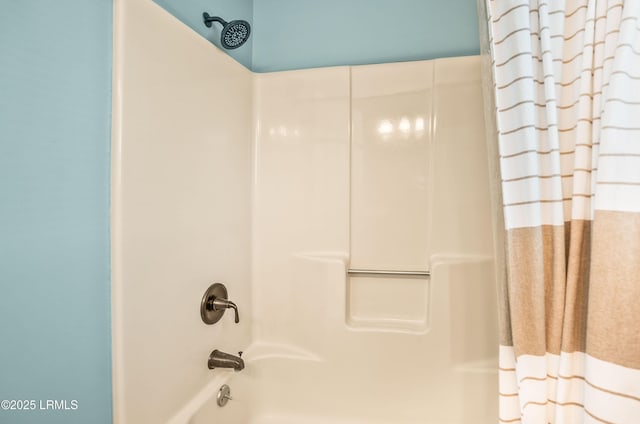 bathroom with shower / bath combo with shower curtain