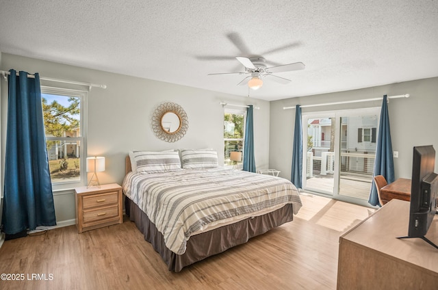 bedroom with access to exterior, light wood-style flooring, a textured ceiling, and a ceiling fan