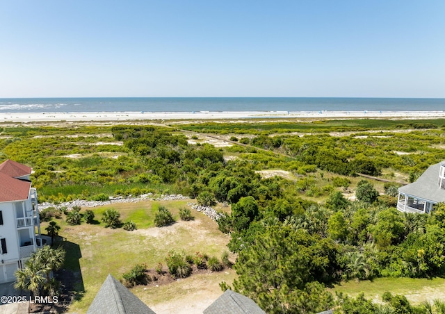 birds eye view of property with a water view and a beach view