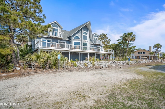 back of property with a balcony