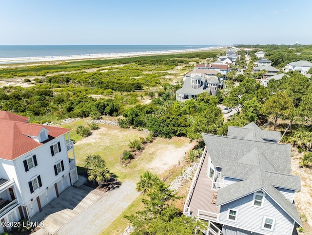 bird's eye view featuring a water view and a view of the beach