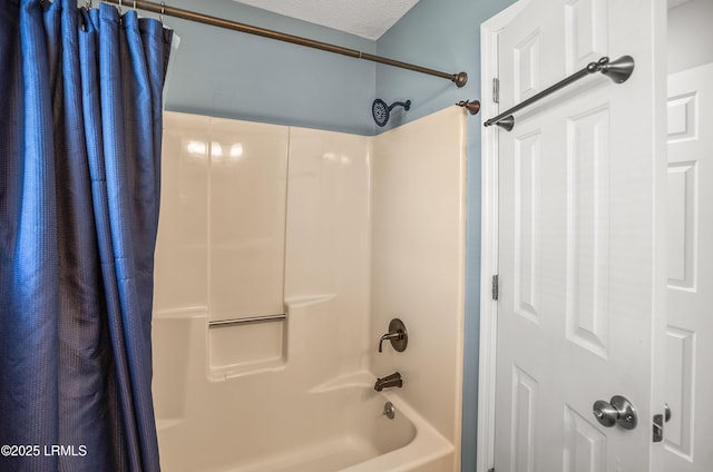 bathroom with a textured ceiling and shower / bath combination with curtain