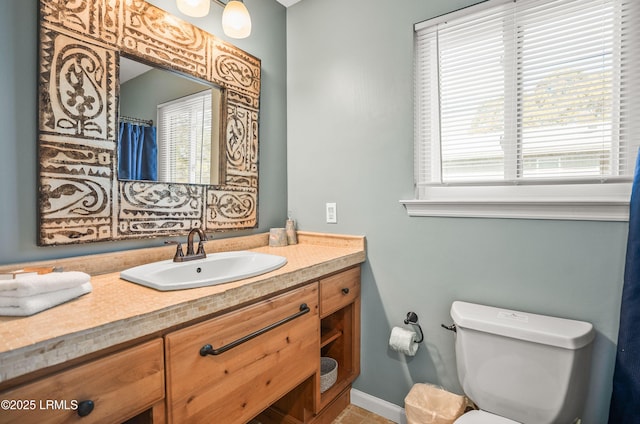 bathroom featuring vanity and toilet